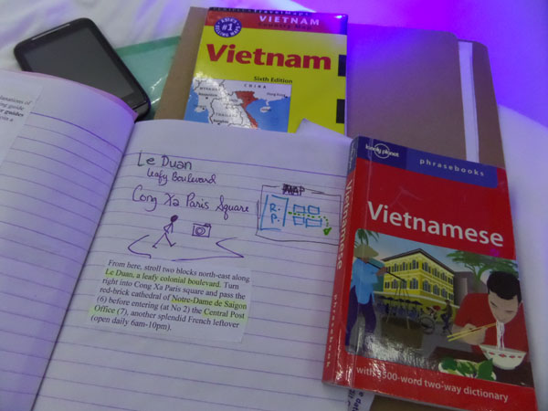 Saigon solo trip preparation with maps, language guide and personal travel notebook