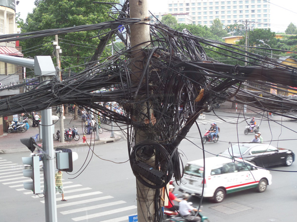 electrical post with lots of wires on a Saigon street