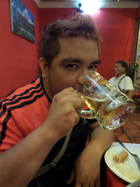 Ethan posing with Cambodian draft beer