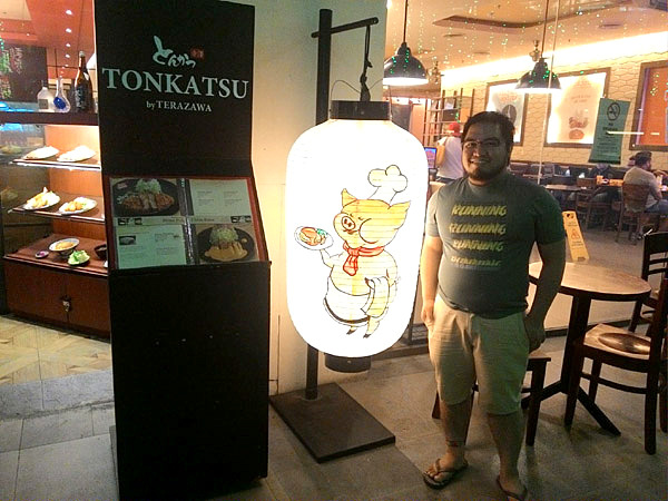 Ethan with Tonkatsu restaurant front and signage in Ayala Center Cebu