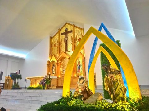 church altar in golden-colour theme during Philippine's midnight mass or simbang gabi